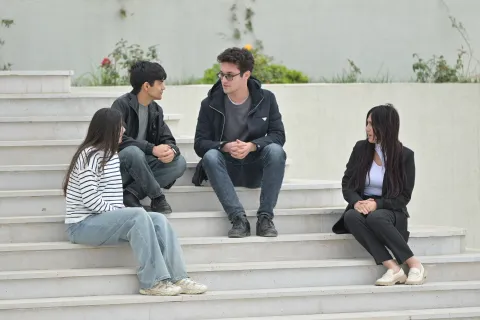 Students sitting on stairs and talking